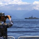 FILE – In this photo provided by China’s Xinhua News Agency, a People’s Liberation Army member looks through binoculars during military exercises as Taiwan’s frigate Lan Yang is seen at the rear on Aug. 5, 2022. China on Wednesday, Aug. 10, reaffirmed its threat to use military force to bring self-governing Taiwan under its control, amid threatening Chinese military exercises that have raised tensions between the sides to their highest level in years. (Lin Jian/Xinhua via AP, File)
