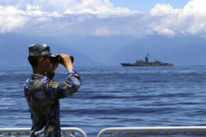 FILE – In this photo provided by China’s Xinhua News Agency, a People’s Liberation Army member looks through binoculars during military exercises as Taiwan’s frigate Lan Yang is seen at the rear on Aug. 5, 2022. China on Wednesday, Aug. 10, reaffirmed its threat to use military force to bring self-governing Taiwan under its control, amid threatening Chinese military exercises that have raised tensions between the sides to their highest level in years. (Lin Jian/Xinhua via AP, File)