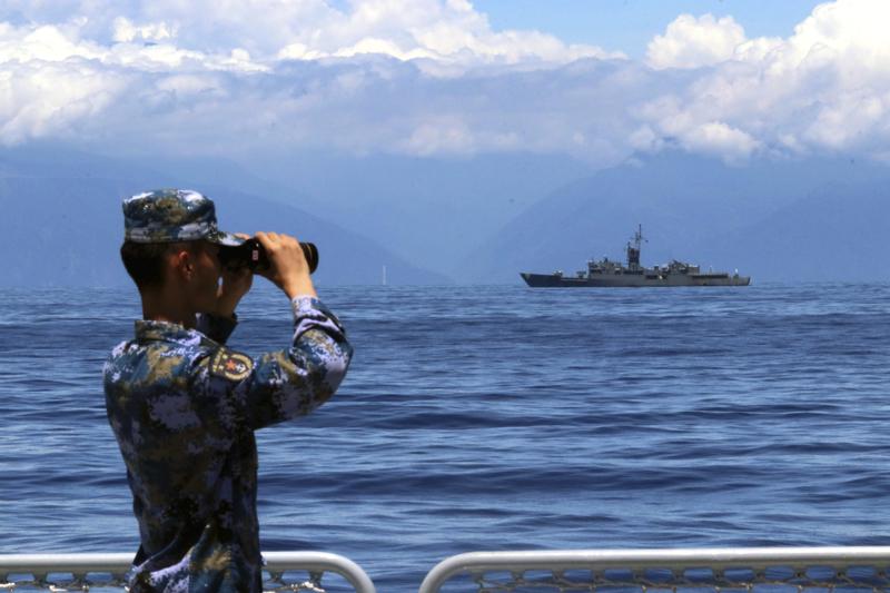 FILE – In this photo provided by China’s Xinhua News Agency, a People’s Liberation Army member looks through binoculars during military exercises as Taiwan’s frigate Lan Yang is seen at the rear on Aug. 5, 2022. China on Wednesday, Aug. 10, reaffirmed its threat to use military force to bring self-governing Taiwan under its control, amid threatening Chinese military exercises that have raised tensions between the sides to their highest level in years. (Lin Jian/Xinhua via AP, File)