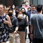 Office workers go for lunch at the central business district on the first day free of coronavirus disease (COVID-19) restrictions, in Singapore, April 26, 2022. REUTERS/Edgar Su