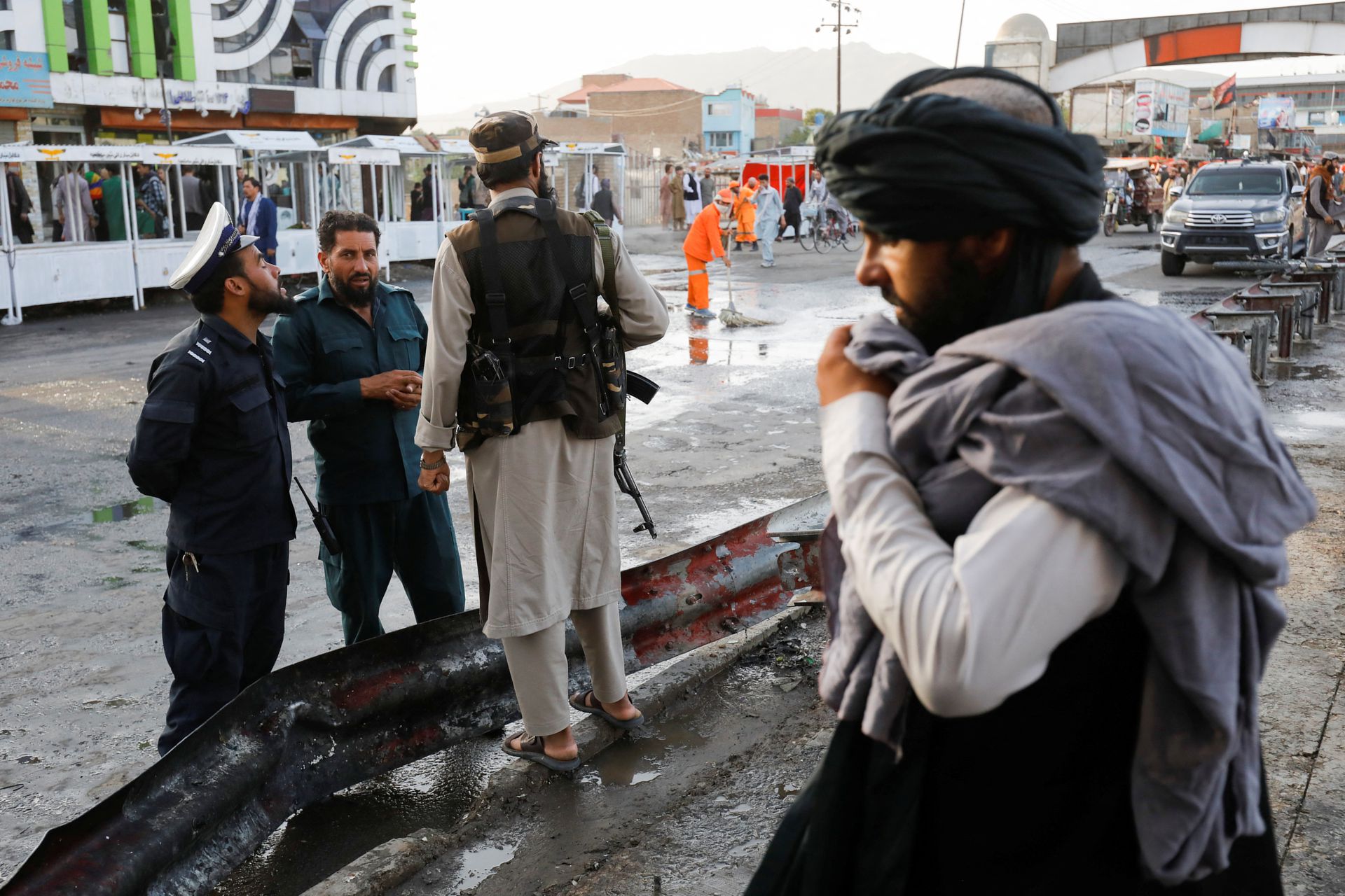 Taliban fighters stand guard at the site of a blast in Kabul, Afghanistan, August 6, 2022. REUTERS/Ali Khara
