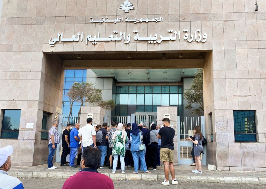 People gather at an entrance of the Ministry of Education and Higher Education during intermittent workers strike in Beirut, Lebanon August 17, 2022. REUTERS/Mohamed Azakir