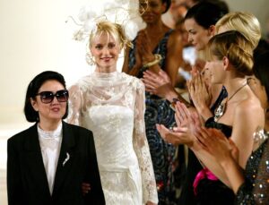 Models applaud Japanese designer Hanae Mori (L) at the end of her Haute Couture 2003-2004 Autumn-Winter collection in Paris, July 9, 2003.