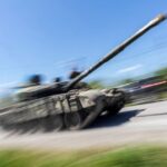 Ukrainian service members ride on top of a tank along a road, amid Russia’s invasion of Ukraine, near the town of Pokrovsk, Donetsk region, Ukraine, May 25, 2022. REUTERS/Carlos Barria