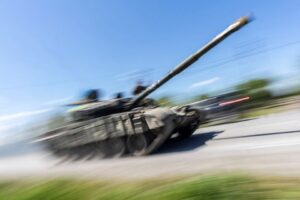 Ukrainian service members ride on top of a tank along a road, amid Russia’s invasion of Ukraine, near the town of Pokrovsk, Donetsk region, Ukraine, May 25, 2022. REUTERS/Carlos Barria