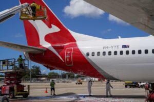 Aircraft appearance crew members clean an aircraft as Qantas begins preparing and equipping planes for the return of international flights, in anticipation of Australia easing coronavirus disease (COVID-19) border regulations, at Sydney Airport in Sydney, Australia, October 21, 2021. REUTERS/Loren Elliott/File Photo