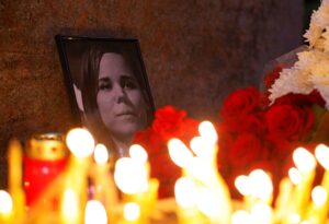Flowers and candles are placed next to a portrait of media commentator Darya Dugina, who was killed in a car bomb attack, in Moscow, Russia August 22, 2022. REUTERS/Maxim Shemetov
