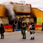 Security forces stand outside a convenience store that was burned by unknown attackers, in a simultaneous attack of fires in different parts of the city, according to local media, in Ciudad Juarez, Mexico, August 11, 2022. REUTERS/Jose Luis Gonzalez