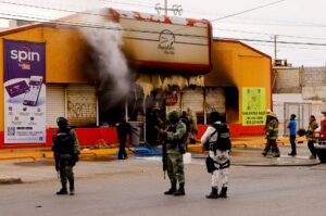 Security forces stand outside a convenience store that was burned by unknown attackers, in a simultaneous attack of fires in different parts of the city, according to local media, in Ciudad Juarez, Mexico, August 11, 2022. REUTERS/Jose Luis Gonzalez