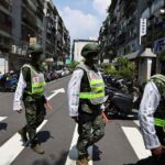 Military police officers get into position for a drill on how to guide citizens to safety in the event of an attack, in Taipei, Taiwan July 22, 2022. REUTERS/Ann Wang