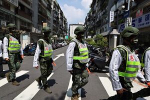 Military police officers get into position for a drill on how to guide citizens to safety in the event of an attack, in Taipei, Taiwan July 22, 2022. REUTERS/Ann Wang
