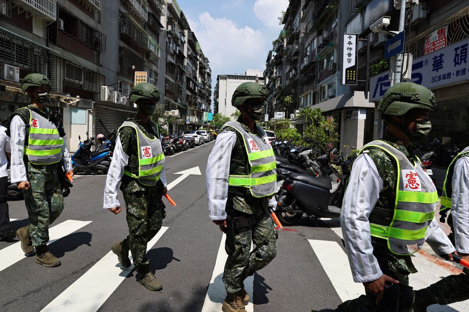 Military police officers get into position for a drill on how to guide citizens to safety in the event of an attack, in Taipei, Taiwan July 22, 2022. REUTERS/Ann Wang