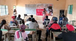 Project-Assitant-Connected-Development-Ms-Zaraphat-Haruna-addressing-participants-during-a-townhall-meeting-on-constituency-projects-at-Narayi-Community-Kaduna-1320×718