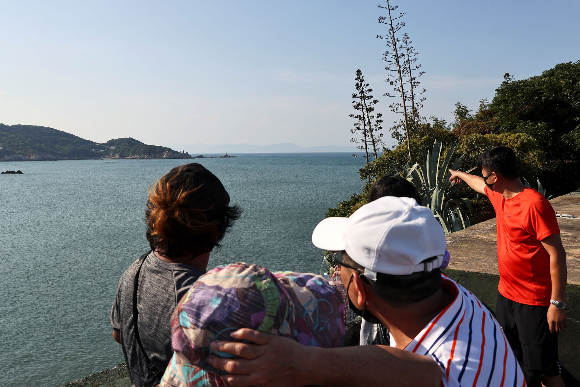 Visitors look at the coast of China across the sea from a battlefield culture museum at the site of a former military fort on Nangan island of Matsu archipelago in Taiwan August 16, 2022. REUTERS/Ann Wang