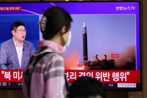 A woman watches a TV broadcasting a news report on North Korea’s launch of three missiles including one thought to be an intercontinental ballistic missile (ICBM), in Seoul, South Korea, May 25, 2022. REUTERS/Kim Hong-Ji