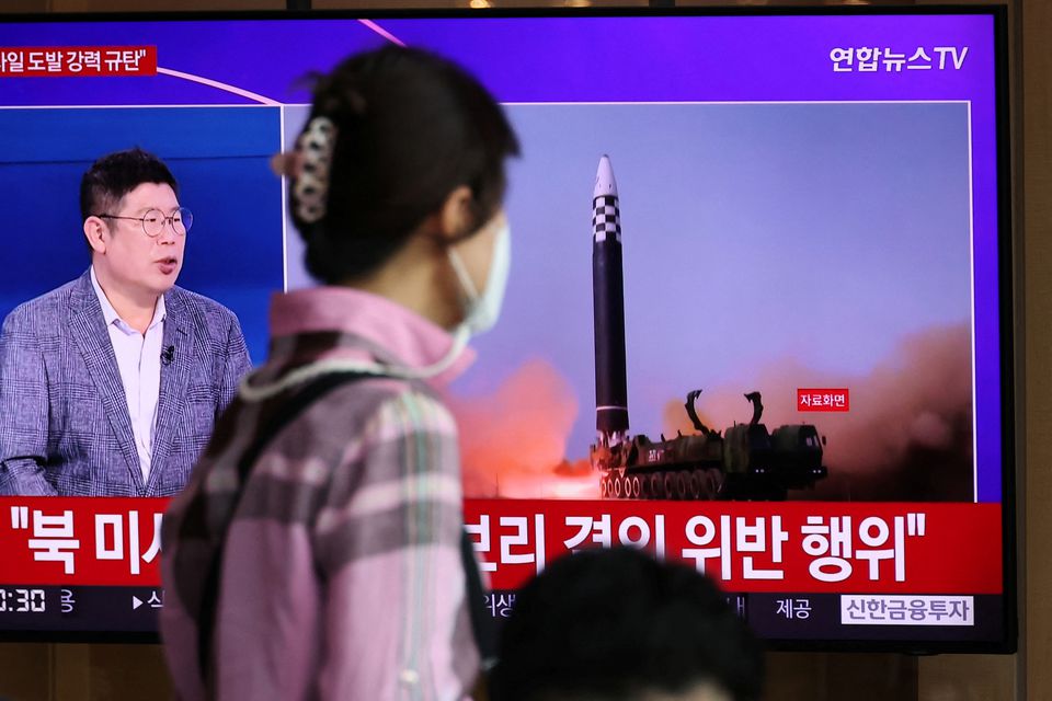 A woman watches a TV broadcasting a news report on North Korea’s launch of three missiles including one thought to be an intercontinental ballistic missile (ICBM), in Seoul, South Korea, May 25, 2022. REUTERS/Kim Hong-Ji