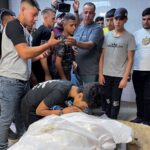 SENSITIVE MATERIAL. THIS IMAGE MAY OFFEND OR DISTURB People react next to the body of Palestinian Waseem Khalifa, 18, who was killed by Israeli forces during clashes in a raid, in Nablus in the Israeli-occupied West Bank, August 18, 2022. REUTERS/Adel Abu Nemeh