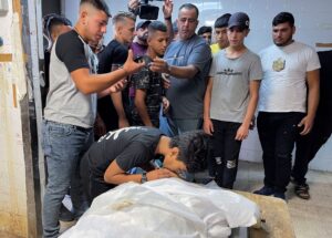 SENSITIVE MATERIAL. THIS IMAGE MAY OFFEND OR DISTURB People react next to the body of Palestinian Waseem Khalifa, 18, who was killed by Israeli forces during clashes in a raid, in Nablus in the Israeli-occupied West Bank, August 18, 2022. REUTERS/Adel Abu Nemeh