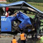 Rescuers work as a crane removes the bus with Polish licence plates that slipped off a road, from the scene near Varazdin, northwestern Croatia, August 6, 2022. REUTERS/Antonio Bronic