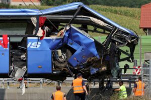 Rescuers work as a crane removes the bus with Polish licence plates that slipped off a road, from the scene near Varazdin, northwestern Croatia, August 6, 2022. REUTERS/Antonio Bronic