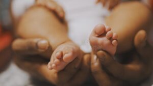 black-father-playing-baby-feet-close-up-high-quality-photo-black-father-playing-baby-feet-close-up-209406296