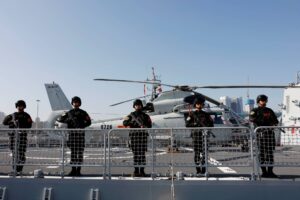 Chinese PLA Navy soldiers stand guard on the guided missile destroyer Xining as they depart for the escort mission in the Gulf of Aden and off the Somali coast, at a port in Qingdao