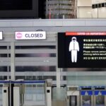 A notice about COVID-19 safety measures is pictured next to closed doors at a departure hall of Narita international airport on the first day of closed borders to prevent the spread of the new coronavirus Omicron variant in Narita, east of Tokyo, Japan, November 30, 2021. REUTERS/Kim Kyung-Hoon