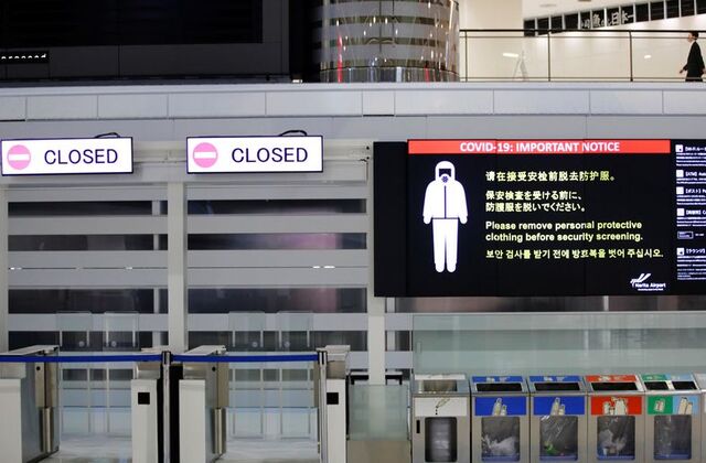 A notice about COVID-19 safety measures is pictured next to closed doors at a departure hall of Narita international airport on the first day of closed borders to prevent the spread of the new coronavirus Omicron variant in Narita, east of Tokyo, Japan, November 30, 2021. REUTERS/Kim Kyung-Hoon