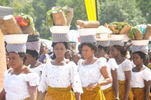 women displaying their tubers of yams