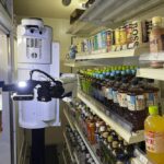 TX SCARA robot works, stocking drinks in the refrigerated section of a FamilyMart convenience store in Tokyo, Friday, Aug. 26, 2022. The robot can restock shelves with up to 1,000 bottles and cans a day. (AP Photo/Yuri Kageyama)