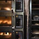 Pastries are cooked inside the oven at Babushka Artisanal Bakery in Budapest, Hungary, Friday, Sept. 9, 2022. The gourmet bakery has raised its prices by 10% to keep up with rapidly rising costs of energy and raw materials, and taken steps to moderate its use of electricity to avoid having to close down. (AP Photo/Anna Szilagyi)