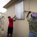 Residents prepare for the arrival of Tropical Storm Fiona, in Loiza, Puerto Rico, Saturday, Sept. 17, 2022. Fiona was expected to become a hurricane as it neared Puerto Rico on Saturday, threatening to dump up to 20 inches (51 centimeters) of rain as people braced for potential landslides, severe flooding and power outages. (AP Photo/Alejandro Granadillo)