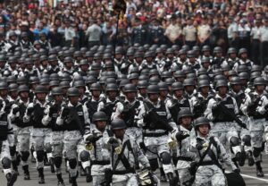 FILE – Members of Mexico’s National Guard march in the Independence Day military parade, in the capital’s main plaza, the Zocalo, in Mexico City, Sept. 16, 2019. Mexico’s President Andres Manuel Lopez Obrador has begun exploring plans to side-step congress to hand formal control of the National Guard to the army. That has raised concerns, because Lopez Obrador won approval for creating the force in 2019 by pledging in the constitution that it would be under nominal civilian control and that the army would be off the streets by 2024. (AP Photo/Marco Ugarte, File)