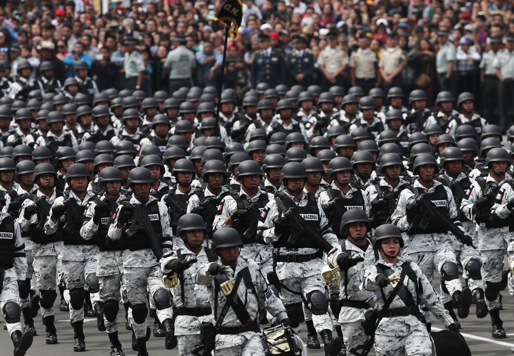 FILE – Members of Mexico’s National Guard march in the Independence Day military parade, in the capital’s main plaza, the Zocalo, in Mexico City, Sept. 16, 2019. Mexico’s President Andres Manuel Lopez Obrador has begun exploring plans to side-step congress to hand formal control of the National Guard to the army. That has raised concerns, because Lopez Obrador won approval for creating the force in 2019 by pledging in the constitution that it would be under nominal civilian control and that the army would be off the streets by 2024. (AP Photo/Marco Ugarte, File)