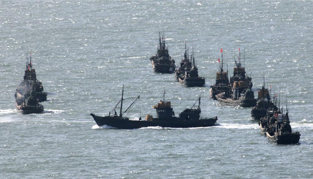 FILE – Chinese fishing boats gather near the South Korea’s western Yeonpyong Island, near the disputed sea border with communist North Korea on May 30, 2009. A Chinese scientific ship bristling with surveillance equipment docked in a Sri Lankan port. Hundreds of fishing boats anchored for months at a time among disputed islands in the South China Sea. And ocean-going ferries, built to be capable of carrying heavy vehicles and large loads of people. (AP Photo/Ahn Young-joon, File)