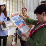 A volunteer of Luhansk regional election commission distributes newspapers to local citizens prior to a referendum in Luhansk, Luhansk People’s Republic controlled by Russia-backed separatists, eastern Ukraine, Thursday, Sept. 22, 2022. Authorities in Russian-controlled regions in eastern and southern Ukraine are preparing to hold referendums on becoming part of Russia — a move that could allow Moscow to escalate the war. The votes start Friday in the Luhansk, Kherson and partly Russian-controlled Zaporizhzhia and Donetsk regions. Writing on newspaper reads in Russian “27.09 Yes.” (AP Photo)