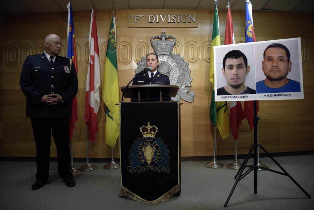 Assistant Commissioner Rhonda Blackmore speaks while Regina Police Chief Evan Bray, left, looks on during a press conference at RCMP “F” Division Headquarters in Regina, Saskatchewan, on Sunday, Sept. 4, 2022. Damien Sanderson and Myles Sanderson allegedly stabbed and killed 10 people between James Smith Cree Nation and Weldon, Saskatchewan, on Sunday morning, and the pair are presently at large. (Michael Bell/The Canadian Press via AP)