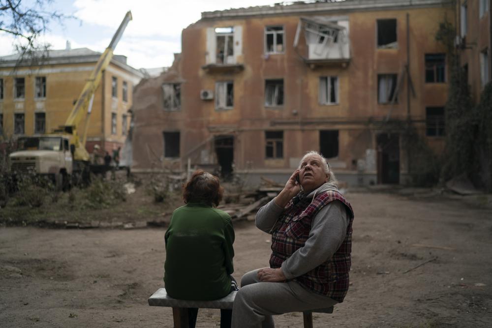 FILE – Raisa Smielkova, 75, looks up as she sits in front of the site were firefighters work to extinguish a fire as they look for potential victims after a Russian attack that heavily damaged a residential building in Sloviansk, Ukraine, on Sept. 7, 2022. Smielkova was sleeping at the time of the explosion. “You would be a fool not to be scared by this,” she says. “If someone asks, I say yes, I am scared.” (AP Photo/Leo Correa, File)