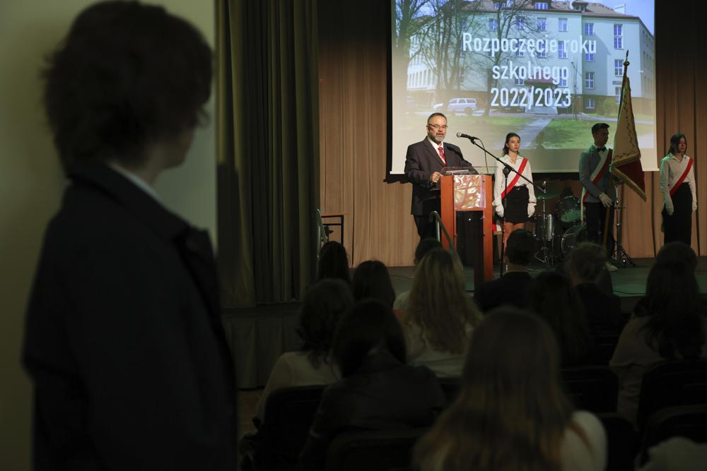 Andrzej Wyrozembski, a school principal at the Limanowski High School, gives an opening speech at the beginning of a new school year in Warsaw, Poland, Thursday, Sept. 1, 2022. The public schools in Poland are facing a shortage of teachers, a problem that is growing increasingly serious each year as people leave the profession over low wages and policies of a government which they fear does not value them. A teachers union and teachers say the situation threatens the education of the country’s youth, though the government insists that they are exaggerating the scale of the problem. (AP Photo/Michal Dyjuk)