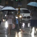 People make their ways in a rain ahead of the approaching Typhoon Hinnamnor in Taipei, Taiwan, Saturday, Sept. 3, 2022. (AP Photo/Chiang Ying-ying)