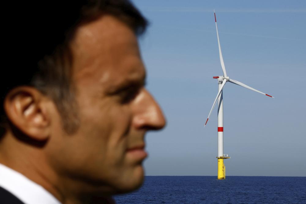 French President Emmanuel Macron visits the Saint-Nazaire offshore wind farm, off the coast of the Guerande peninsula in western France, Thursday, Sept. 22, 2022. (Stephane Mahe/Pool photo via AP)