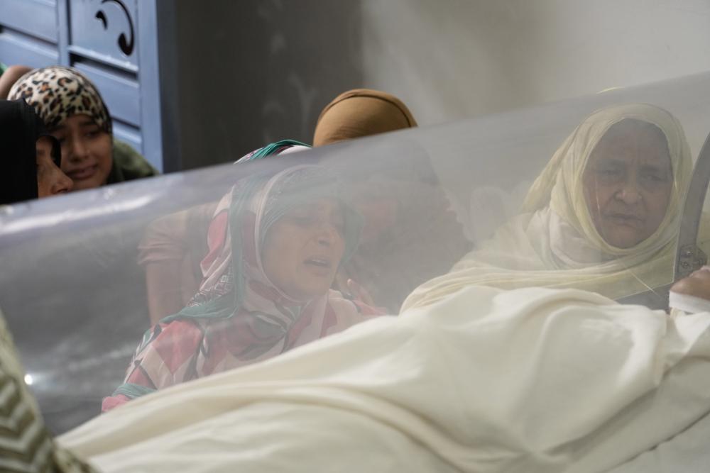 The mother, center, and grandmother, right, weeps near the body of Mohamed Usman, 15, who was killed by lightning on Friday at Prayagraj, in the northern Indian state of Uttar Pradesh, India. Saturday, Sept. 24, 2022. Hazardous weather killed at least 36 people in northern India over the past 24 hours, including 12 who died after being struck by lightning, officials said as they warned of more heavy downpours in the coming days. Usman was walking on the roof when he was struck by lightning. (AP Photo/Rajesh Kumar Singh)