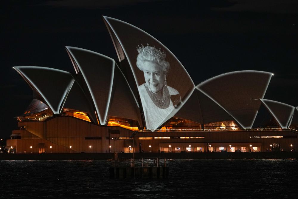 FILE – The Sydney Opera House is illuminated with a portrait of Queen Elizabeth II in Sydney, Australia, on Sept. 9, 2022. Many regarded Australians’ respect and affection for the late Queen Elizabeth II as the biggest obstacle to the country becoming a republic with its own head of state. Now after her death and with a pro-republic Labor Party government in power, Australia’s constitutional ties to the British monarchy will again be open to first-order debate for the first time since change was rejected at a 1999 referendum.(AP Photo/Mark Baker, File)