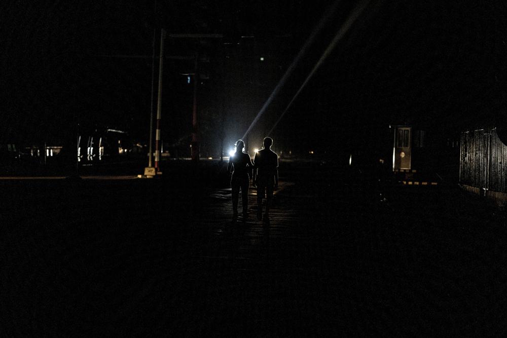 A couple walks down the middle of a street in the dark during a blackout in Havana, Cuba, Wednesday, Sept. 28, 2022. Cuba remained in the dark early Wednesday after Hurricane Ian knocked out its power grid and devastated some of the country’s most important tobacco farms when it hit the island’s western tip as a major storm. (AP Photo/Ramon Espinosa)