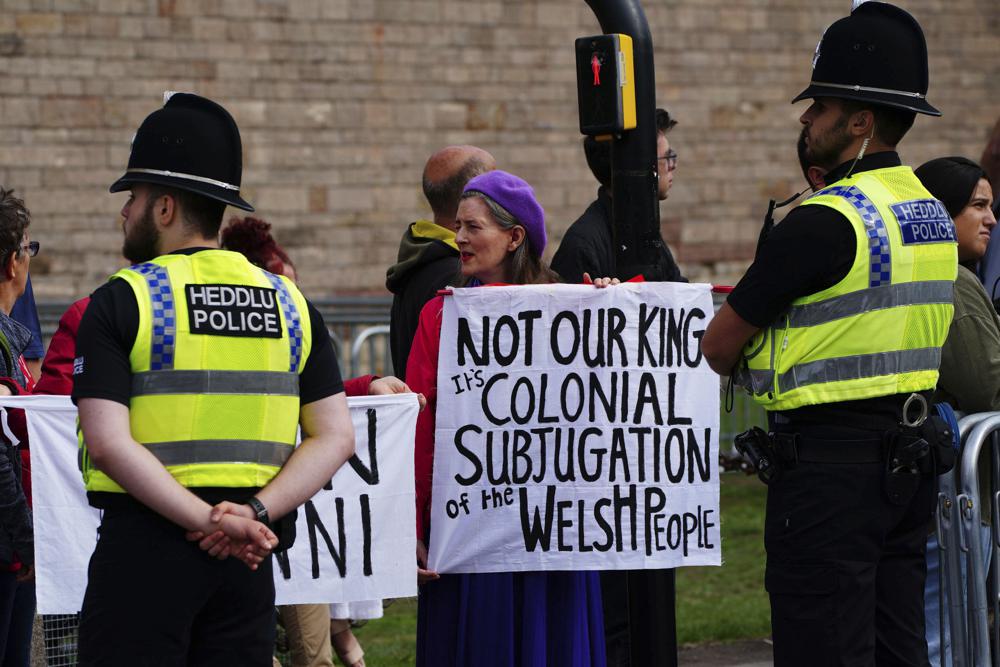 People protest ahead of the Accession Proclamation Ceremony at Cardiff Castle, Wales, publicly proclaiming King Charles III as the new monarch, Sunday Sept. 11, 2022. (Ben Birchall/PA via AP)