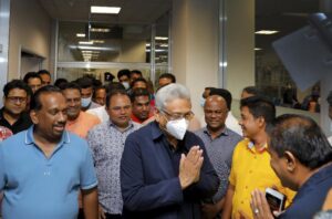 In this handout picture provided by the Ministry of Urban Development and Housing of Government of Sri Lanka, Sri Lanka’s former President Gotabaya Rajapaksa, wearing mask, is greeted upon his arrival at Bandaranaike International airport in Colombo, Sri Lanka, Saturday, Sept. 3, 2022. Gotabaya Rajapaksa, who fled the country in July after tens of thousands of protesters stormed his home and office in a display of anger over the country’s economic crisis, has returned to the country after seven weeks. (Ministry of Urban Development and Housing of Government of Sri Lanka via AP Photo)