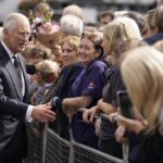 Britain’s King Charles III meets wellwishers outside Hillsborough Castle, Belfast, Tuesday Sept. 13, 2022. King Charles III is flying to Northern Ireland on the latest leg of his tour of the nations that make up the United Kingdom as thousands of people have lined up through the night to pay their last respects to his mother’s coffin in Edinburgh. (Niall Carson/Pool via AP)