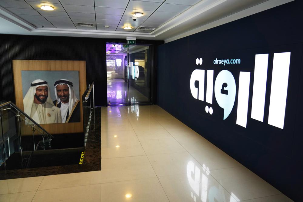 A painting of Sheikh Zayed bin Sultan Al Nahyan, the late leader of the United Arab Emirates and ruler of Abu Dhabi, left, and Sheikh Rashid bin Saeed Al Maktoum, the late ruler of Dubai, hangs outside the offices of the offices of the Al Roeya newspaper in Dubai, UAE, Sept. 3, 2022. A state-linked newspaper published a story this summer about a hot-button issue in the country: How Emiratis are coping with high fuel prices. It ended up seeing over 40 people fired and the paper was declared dissolved. The purge at Al Roeya newspaper reflects the intense challenges facing local journalists in the UAE. (AP Photo/Jon Gambrell)