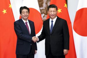 FILE – In this photo released by Xinhua News Agency, Japanese Prime Minister Shinzo Abe, left, shakes hands with Chinese President Xi Jinping as they pose for photographers before a meeting at the Diaoyutai State Guesthouse in Beijing on Oct. 26, 2018. Thursday, Sept. 29, 2022, marks the 50th anniversary of the historic communique that former Japanese Prime Minister Kakuei Tanaka signed with former Chinese Premier Zhou Enlai. (Li Tao/Xinhua via AP, File)