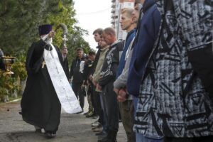 A Russian Orthodox priest blesses a group of recruits at a military recruitment center in Volgograd, Russia, Saturday, Sept. 24, 2022. Russian President Vladimir Putin on Wednesday ordered a partial mobilization of reservists to beef up his forces in Ukraine. (AP Photo)